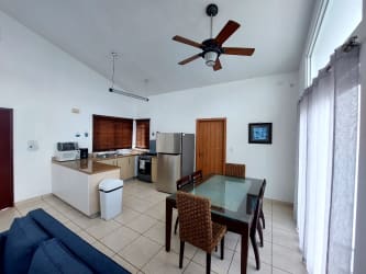 Modern open kitchen with stainless appliances granite counters dining area Playa Malibu Panama