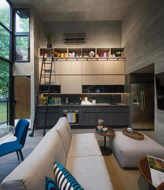 Minimalist kitchen with built-in shelving open to loft living space PH DOVLE Panama