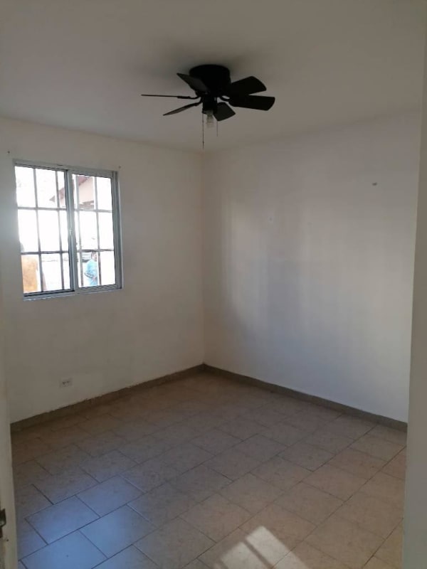 Bedroom with window ceiling fan tile floor in PH Altos de Primavera Villa Lucre Panama