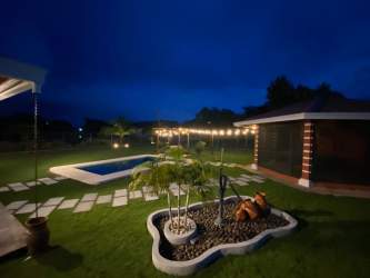 Covered social space with billiard table beside pool in Bejuco Chame house Panama