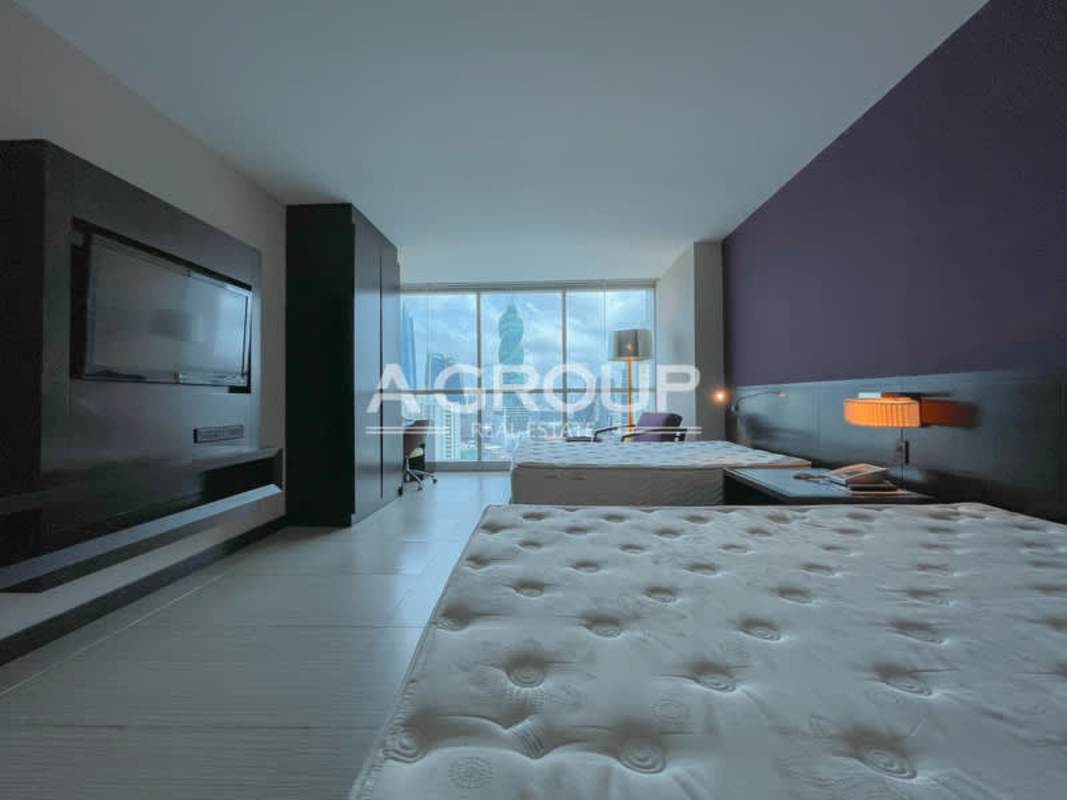 Office corner and living space in luxury PH Megapolis suite with skyline view, floor-to-ceiling windows Marbella Panama
