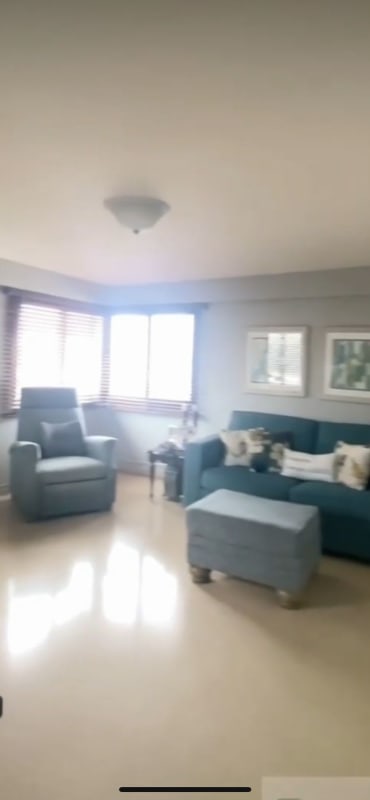 Bright living room with blue sofas windows city view PH Carmel Panama