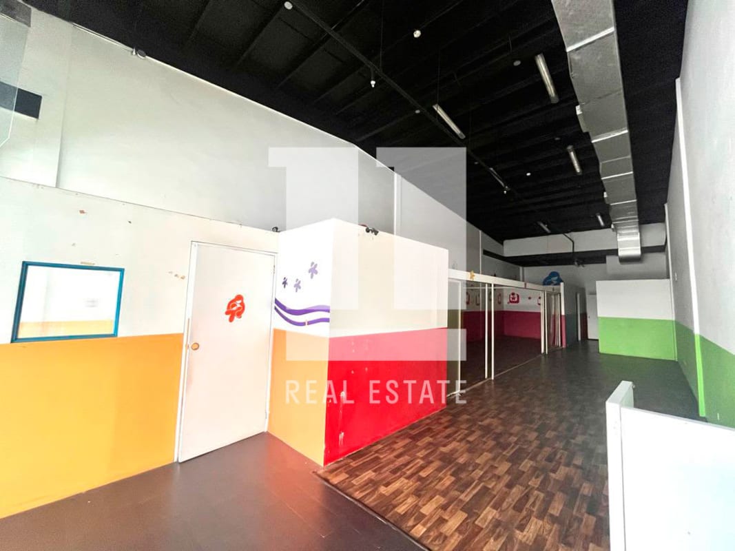 Second-level commercial space with colorful partitions and exposed ceiling Condado del Rey Panama