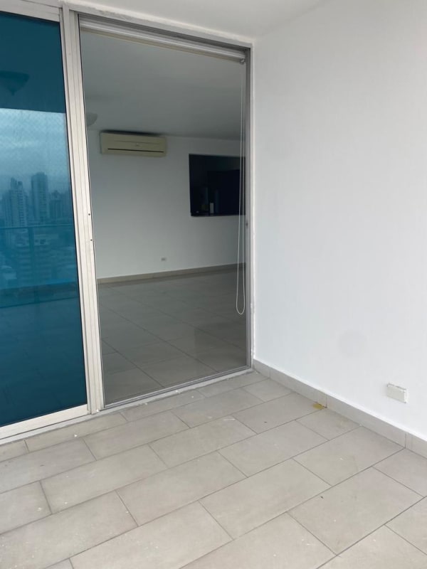 Spacious master bedroom with tile floors, ensuite bathroom, and city window in PH Regent San Francisco Panama