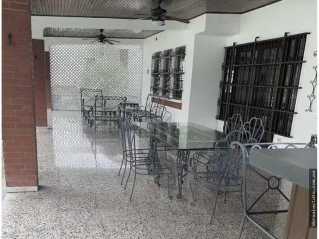 Covered patio with glass dining tables brick columns iron grills Altos del Golf Panama