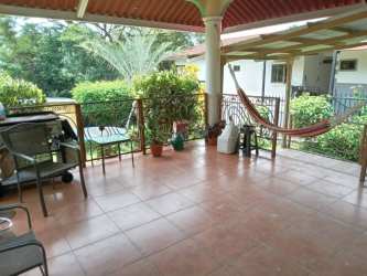 Covered patio with hammock potted plants garden view Terronal David Panama house for sale