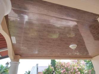 Kitchen with teca wood cabinets, window, appliances in Terronal David Panama home