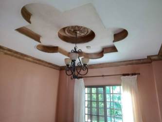 Spacious fenced backyard with lawn mature trees trampoline in Terronal David Panama house