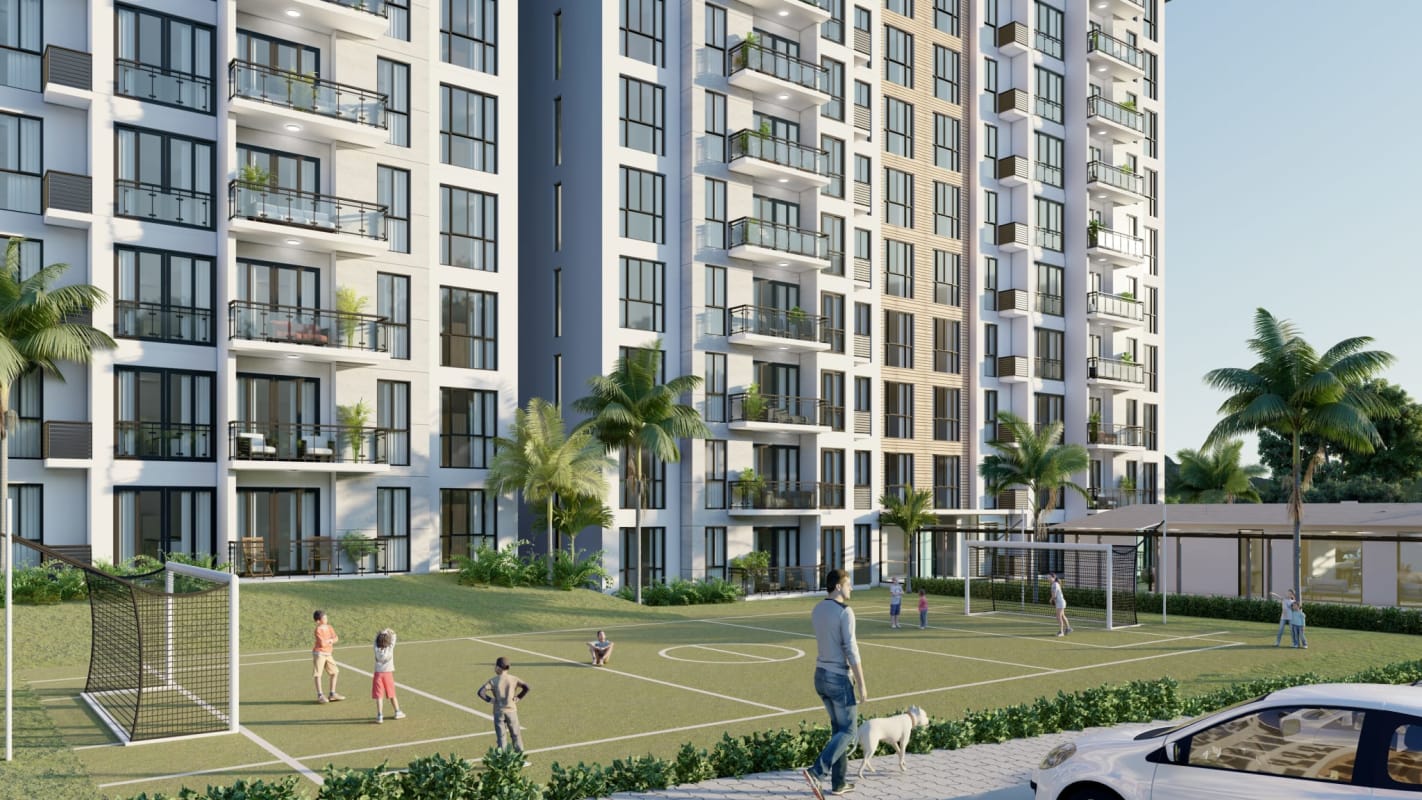 Modern high rise condo with balconies overlooking soccer field gardens palm trees in PH Parque Las Acacias Panama City