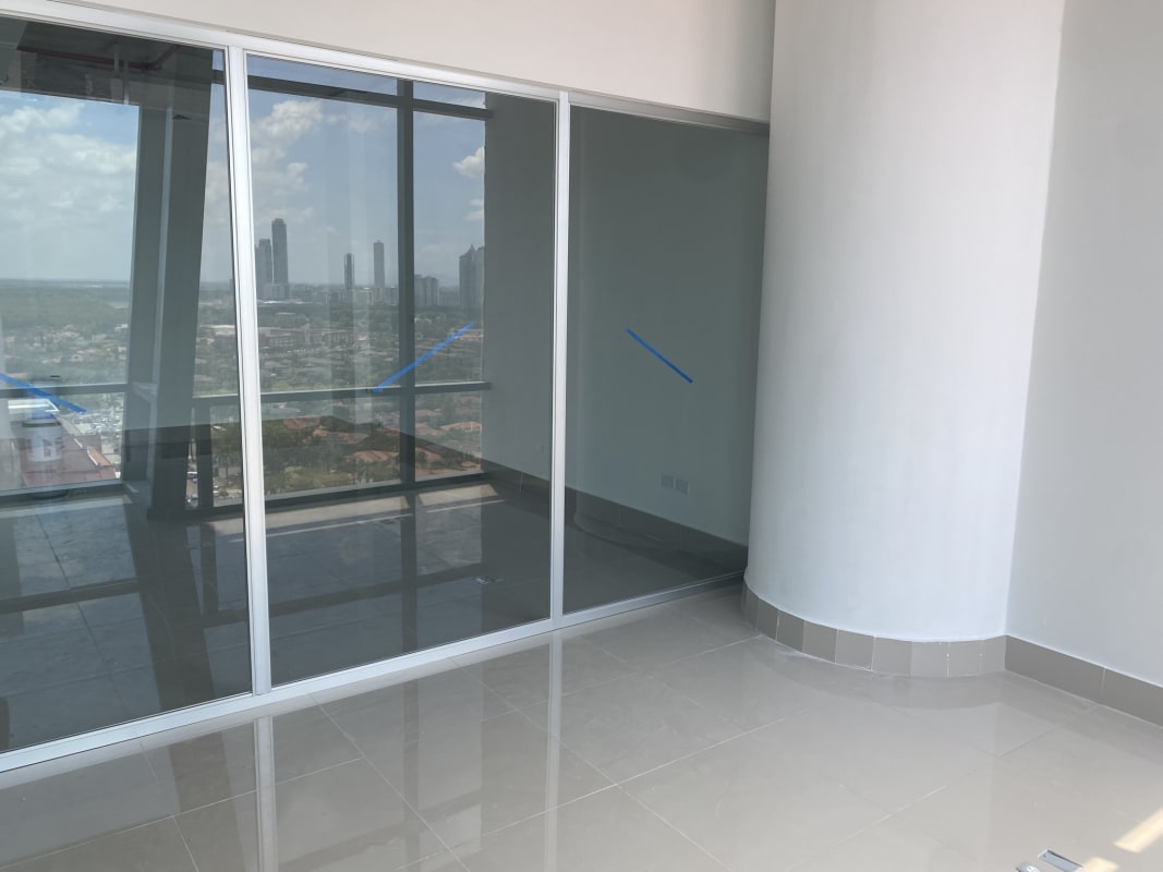 Modern office tower floor with city skyline and ocean view through large windows Costa del Este