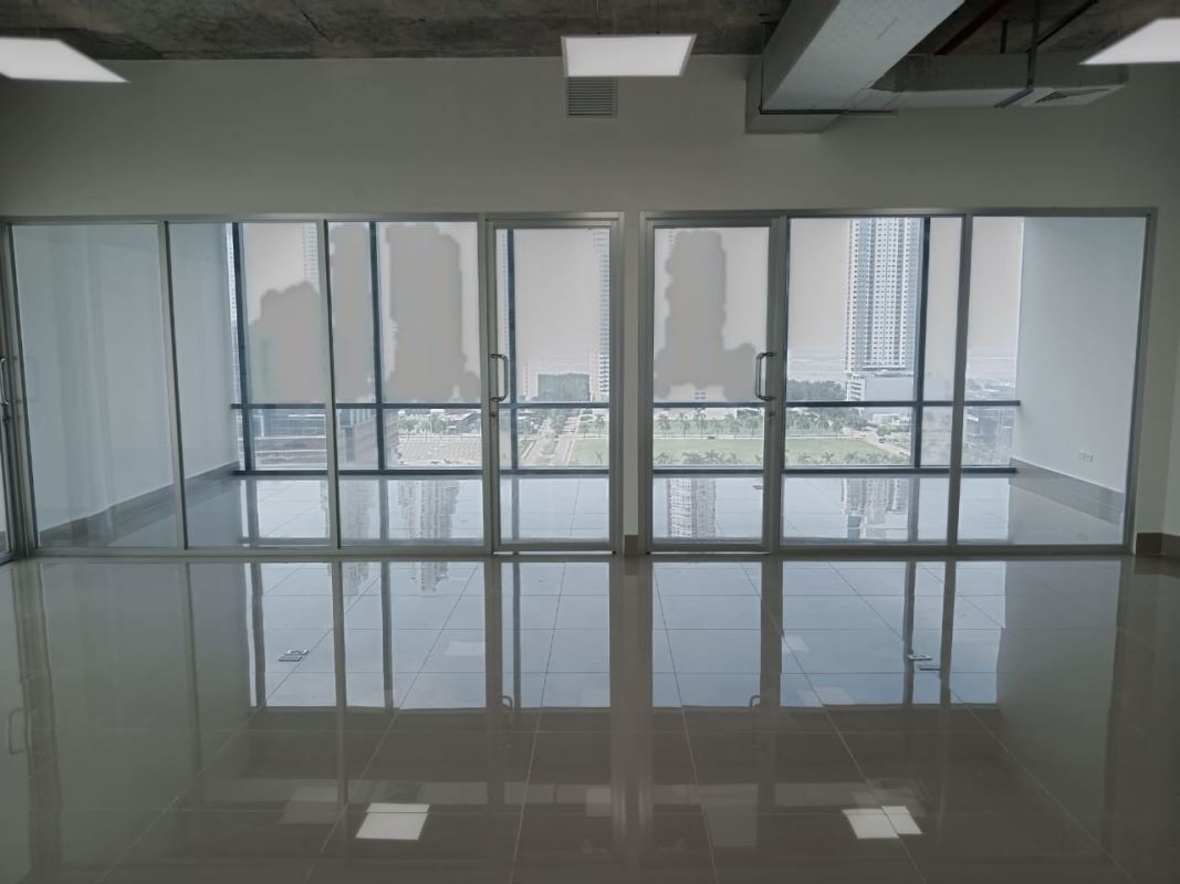 Office area with glass partitions, porcelain flooring and panoramic cityscape in Costa del Este