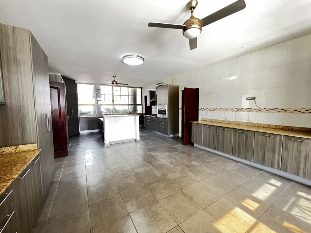 Large kitchen with granite island, built-in stove in luxury house in San Francisco Panama