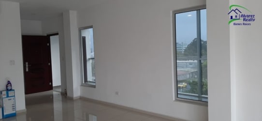 Contemporary kitchen featuring granite countertops and white cabinets at Boquete Vista condominium Panama