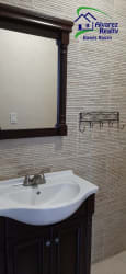 Contemporary bathroom with glass shower enclosure, modern tiled walls and sink vanity in Boquete condo