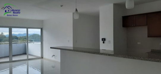 Open-plan living space with balcony access featuring mountain views in a Boquete Panama condo