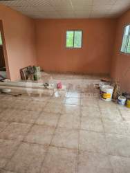 Peach walls bathroom small window walk-in shower rustic house Panama