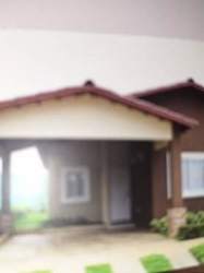 Aerial view of Puerto Caimito gated residential neighborhood with single-story houses and green parks in La Chorrera Panama Oeste