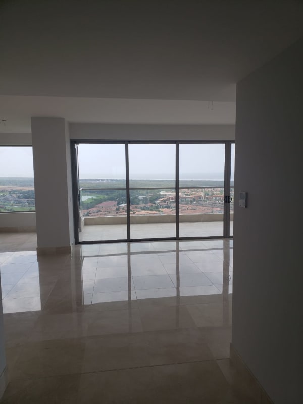Balcony view with glass railing overlooking Santa María cityscape and green golf course