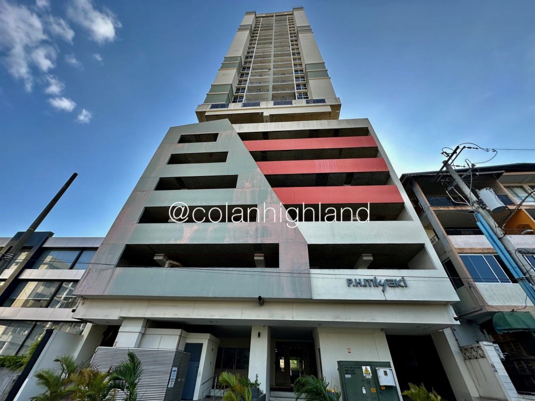 Exterior facade of PH Miyaki modern high-rise with balconies and parking garage in Obarrio Panama