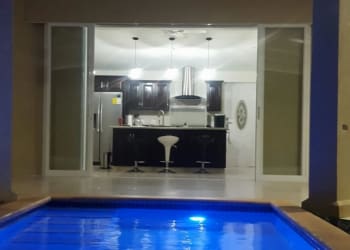 Private pool surrounded by palm trees and patio in El Espino San Carlos house for sale Panama