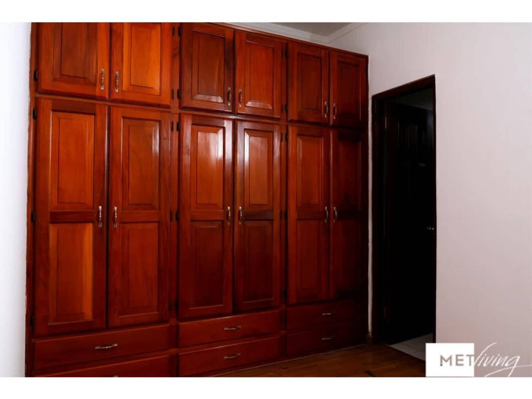 Outdoor covered terrace with hammock, dining, ceiling fan in Obarrio city center home Panama