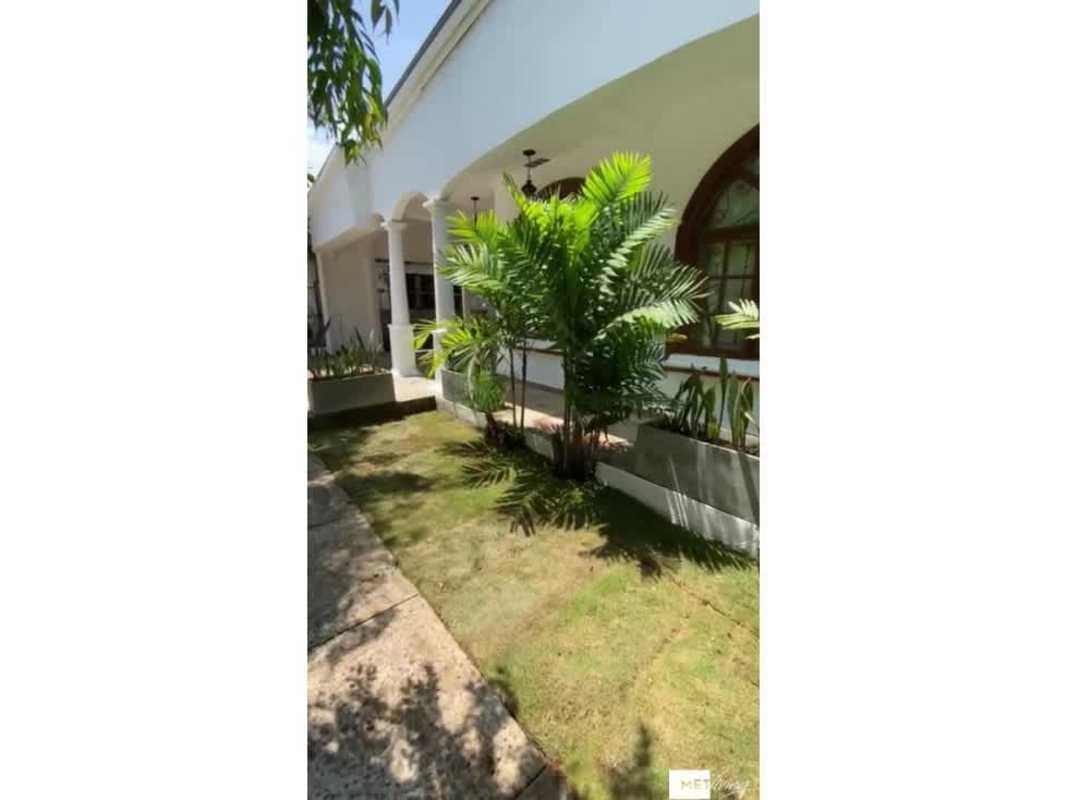 Front exterior of Mediterranean house with arches, garden and porch in Obarrio Panama for sale