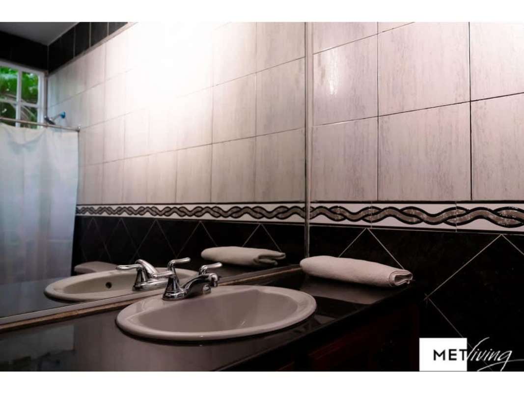 Kitchen with wood cabinets, granite countertop, gas stove, window in Obarrio house for sale