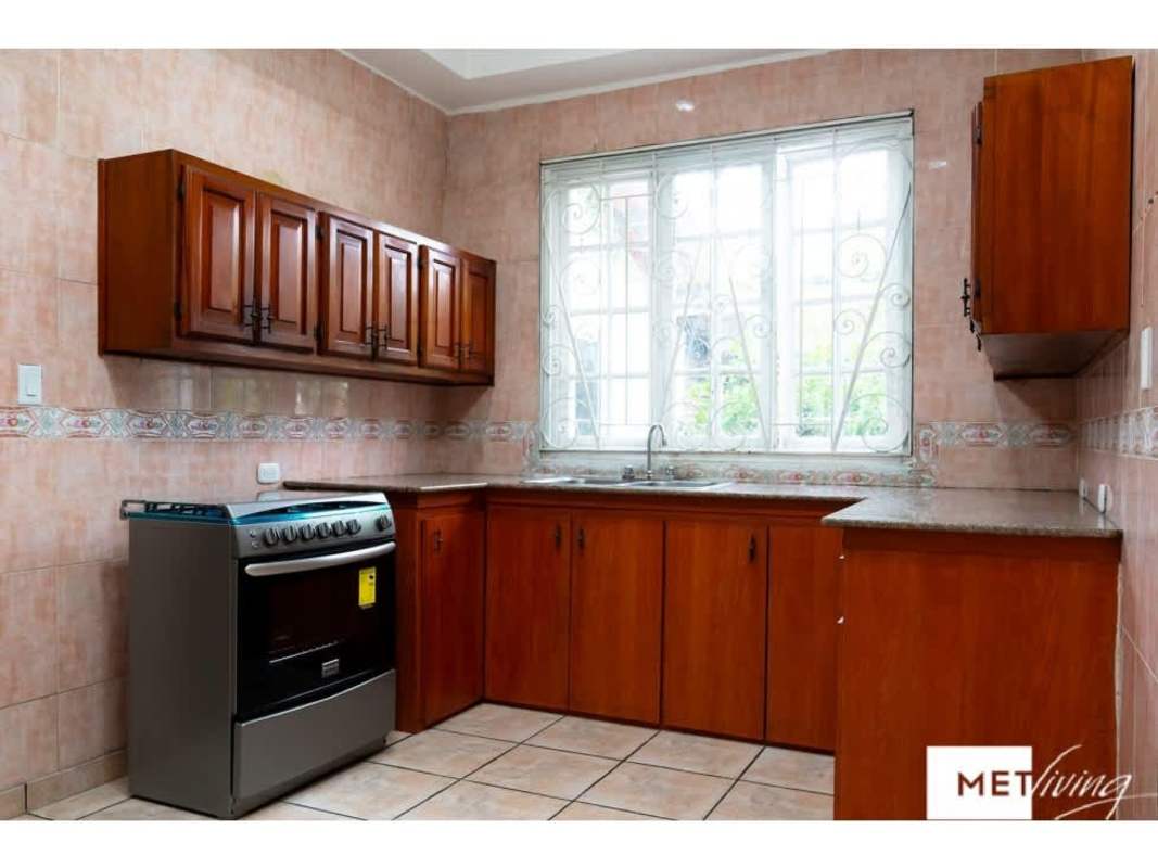Bathroom with double vanity sink, large mirror, decorative tiles in Obarrio house Panama