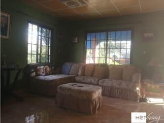 Small yellow bungalow with garden and banana trees in countryside Las Lajas Chame Panama