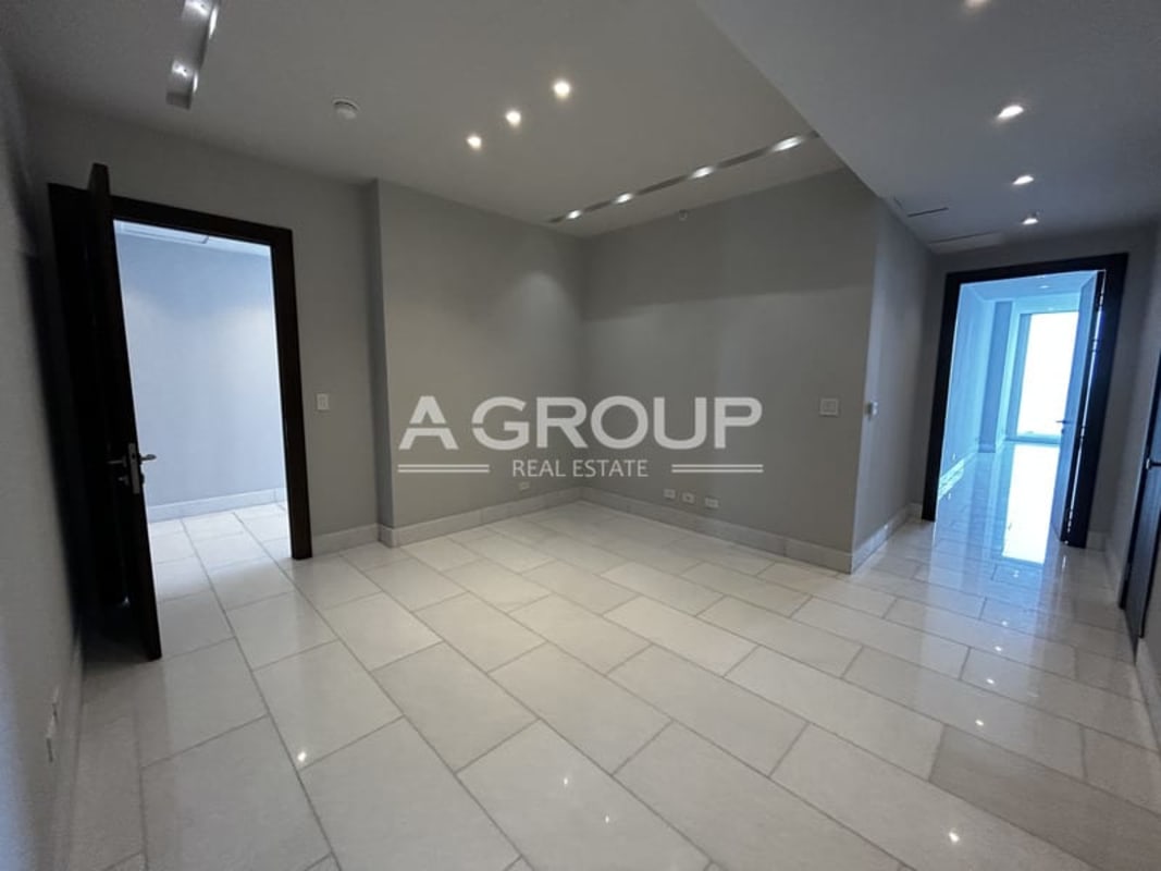 Modern bedroom with large windows, tile floors, minimalist style at The Towers Punta Paitilla Panama