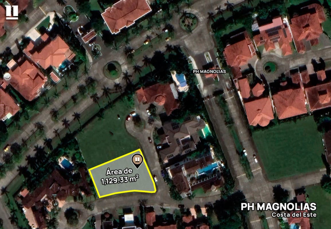 Aerial view of gated neighborhood with empty lot in PH Magnolias Costa del Este featuring Mediterranean homes and pools