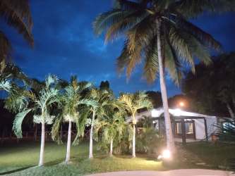 Covered patio with barbecue grill dining tables and fans Villa Brisa Mare beach villa Panama