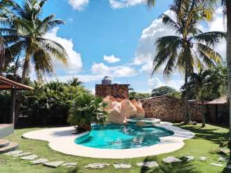 Backyard tropical pool illuminated at night with palm trees Villa Brisa Mare Panama