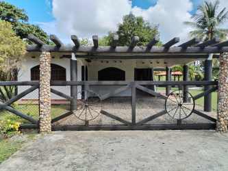 Stone wall gate and pergola rustic entrance Villa Brisa Mare vacation home Panama