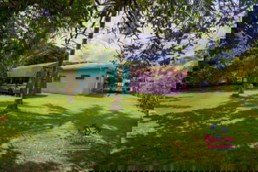 Driveway with covered carport and tropical greenery at Nuevo Farallón Rio Hato house