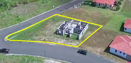 Aerial view of corner lot with unfinished house in Hacienda Pacifica San Carlos Panama