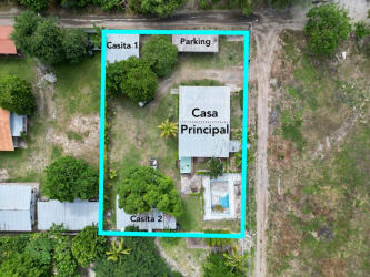 Single story house with shaded patio and lush yard Playa Gorgona Panama