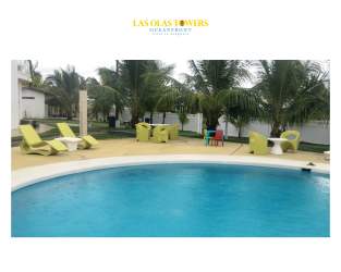 Aerial view showing beachfront condo complex with pool and ocean access at Playa La Barqueta Panama