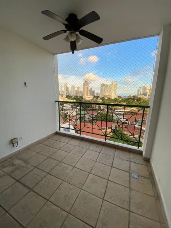 Galley style kitchen with granite, red cabinets, window Via Porras Panama