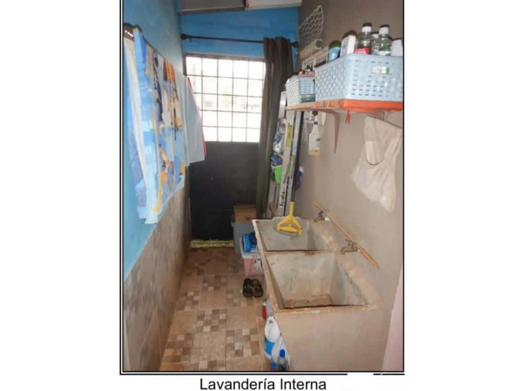 Laundry room with concrete sink, blue wall, storage shelves in Viña del Mar Panama