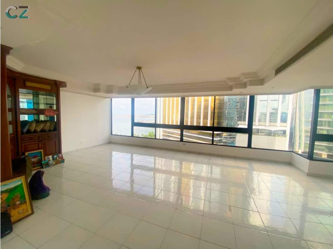 Living room with large corner windows offering panoramic ocean and skyline views in PH Costa del Mar