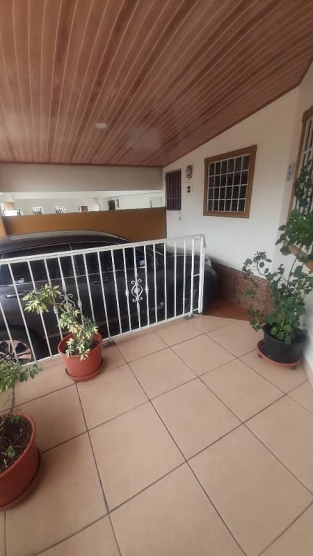 Covered porch entrance and parking Villa Lucre residential house Panama
