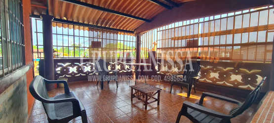 Open-plan living and dining space with tiled floors in Panama home