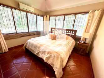Spacious bedroom with double beds, terracotta floors, garden views El Valle estate Panama