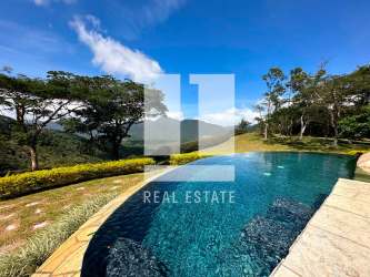 Spacious living room with fireplace, natural stone wall and vaulted ceilings luxury country estate El Valle Panama