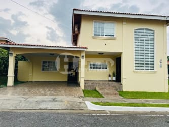Kitchen with wood cabinets black counters Villas del Golf Panama