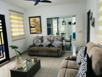 Dining area with glass table and chairs near kitchen Villas del Golf Panama