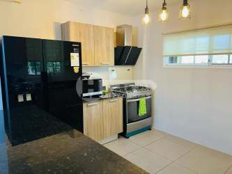 Contemporary living room with ceiling fan and sliding doors Villas del Golf Panama