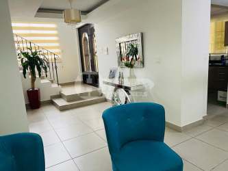 Dining and living space with chandelier and art Villas del Golf Chitre Panama