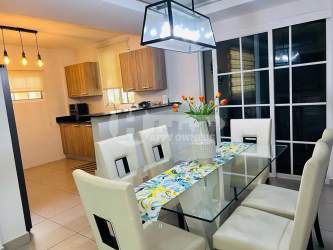 Glass dining table with wood cabinets kitchen Villas del Golf Chitre Panama